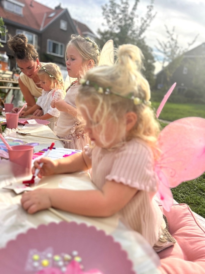 Kinderen met vleugels midden in een opdracht, Jolie helpt mee op de achtergrond